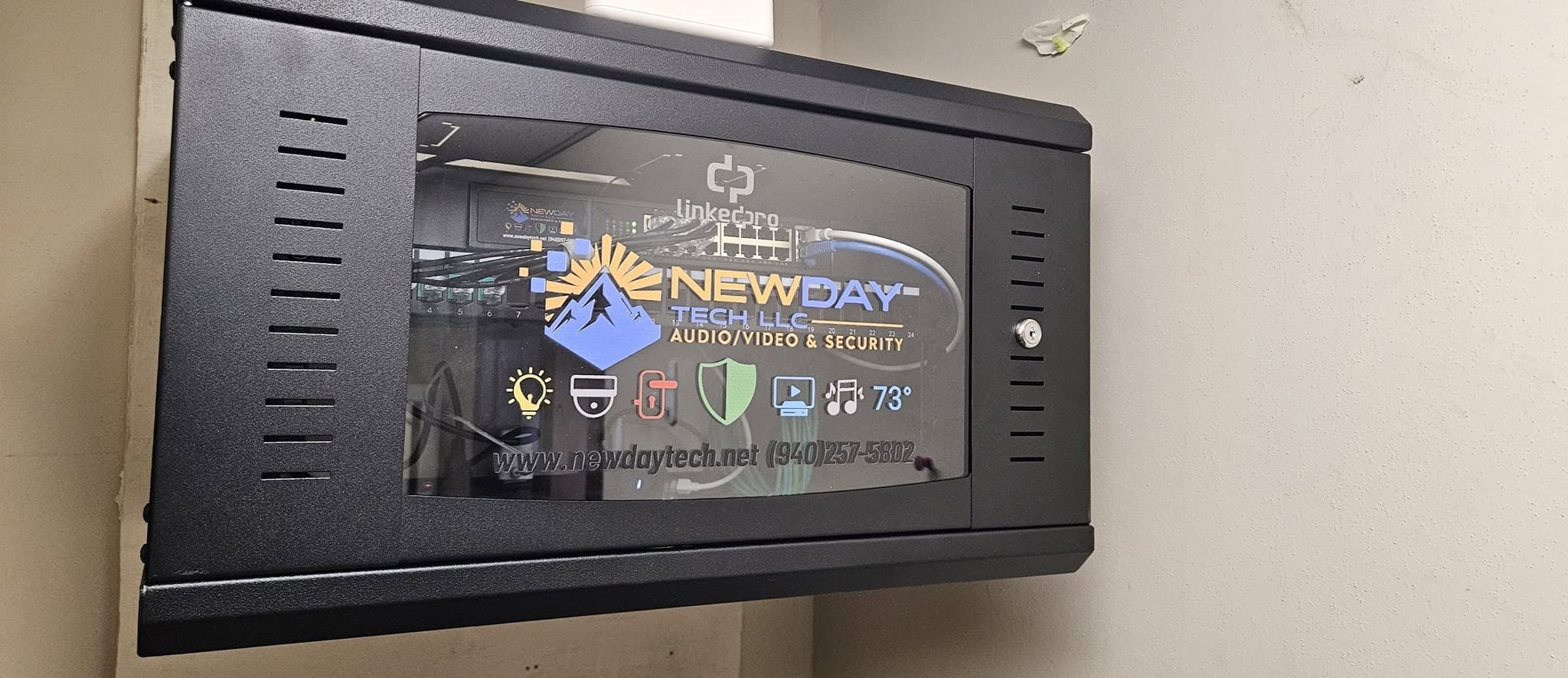 NewDay Tech branded business network cabinet with installed equipment