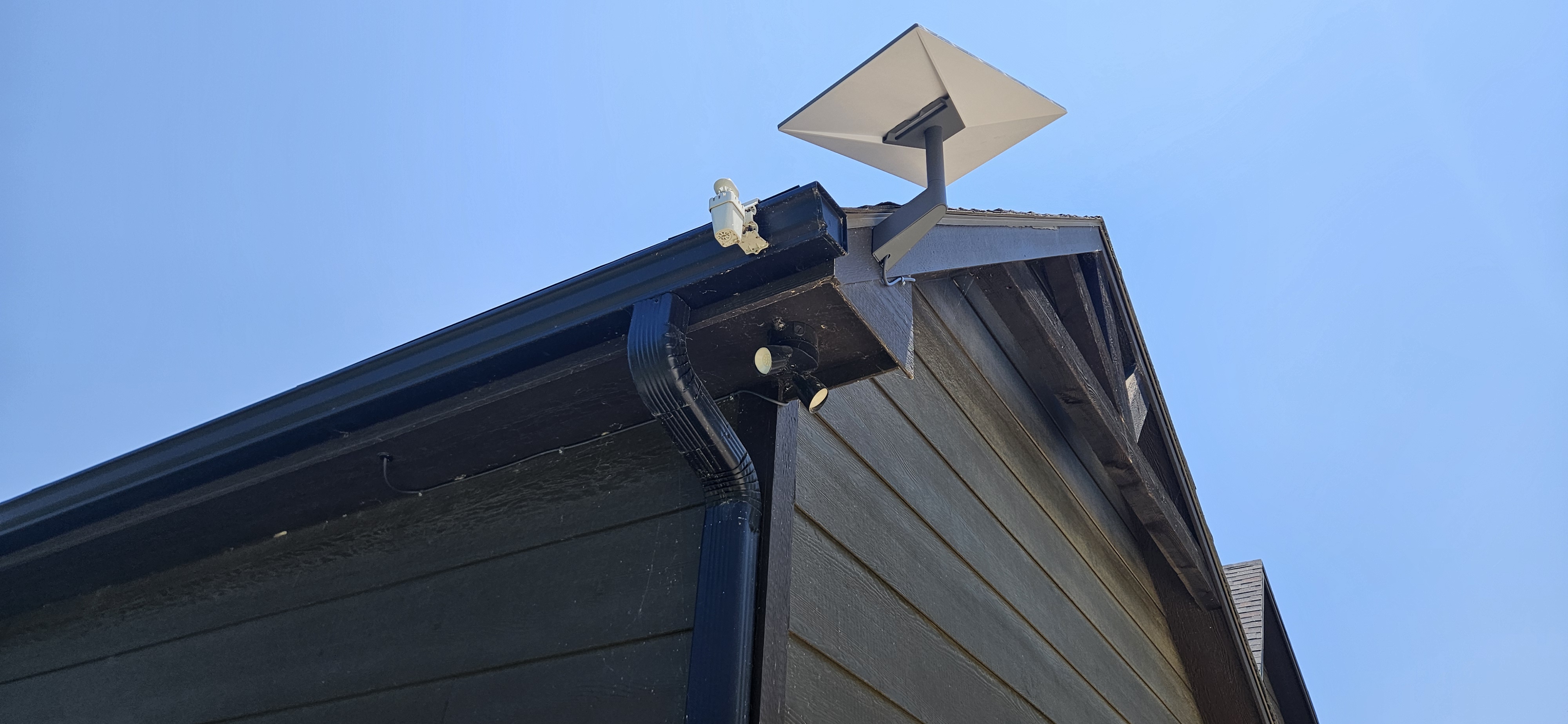 Installed Starlink dish mounted near a residential roofline